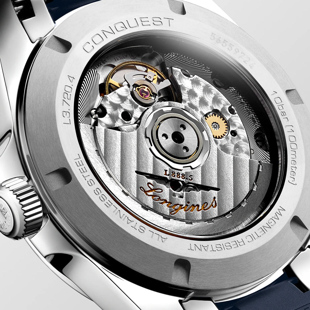 Close-up of the Longines Conquest Automatic 38mm case back reveals its mechanical movement via a transparent window, with engraved details and the Longines logo emphasizing the sporty elegance of this everyday watch.