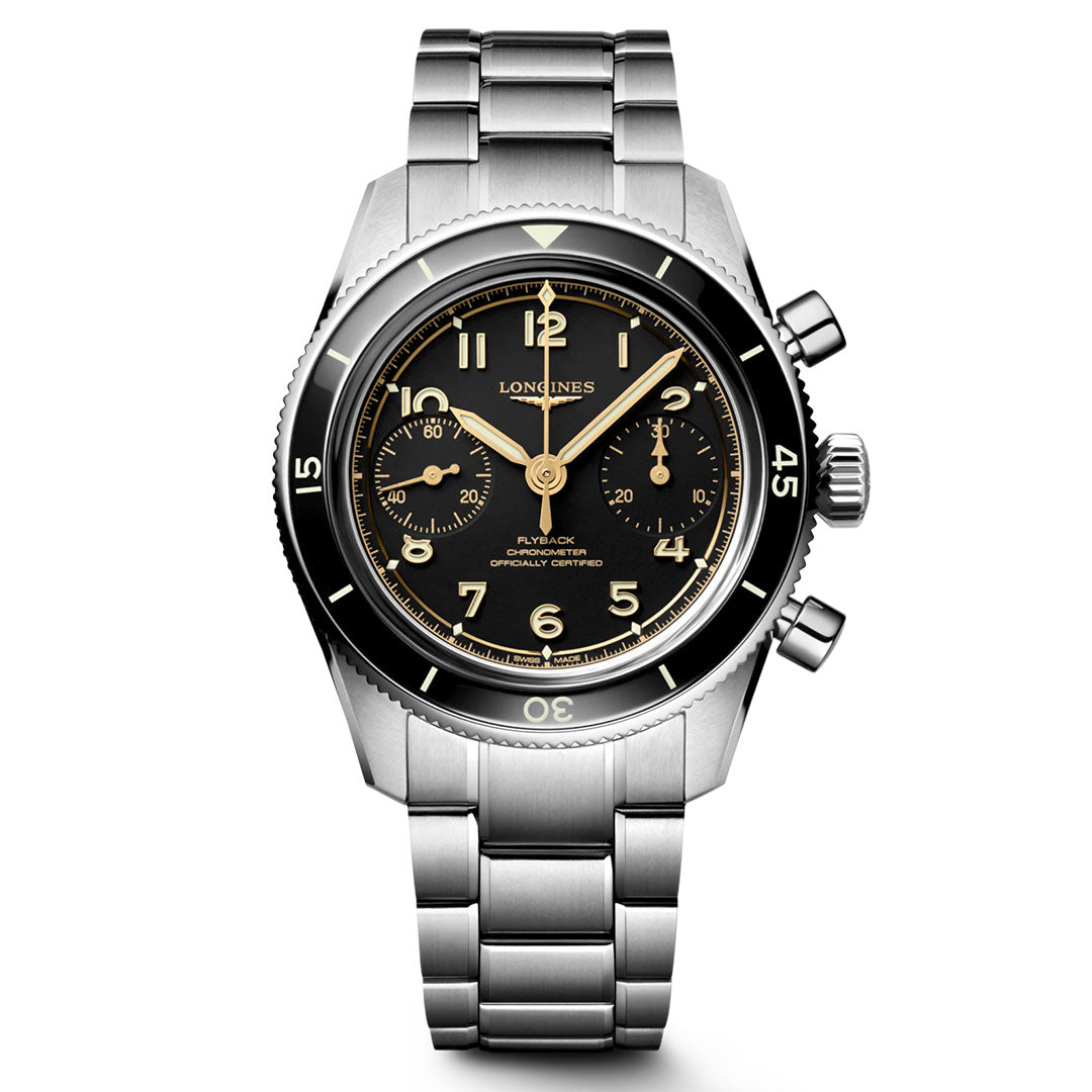 The Longines Spirit Pilot Flyback Automatic Manual Winding 39.5mm Watch features a stainless steel case, black dial with luminous Arabic numerals, two subdials, metal bracelet, minute-marked bezel, pushers, and crown.