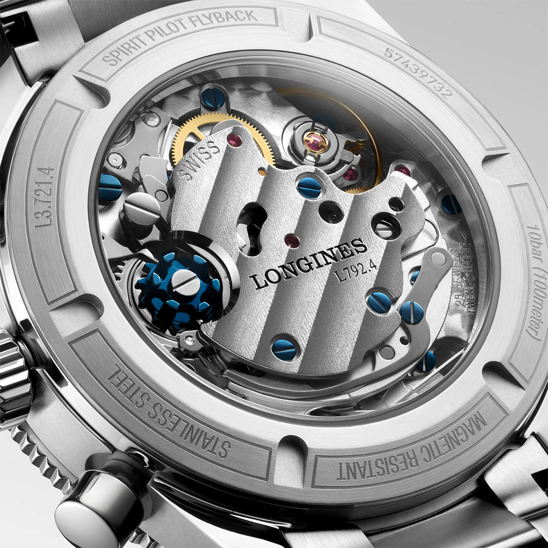 Close-up of the Longines Spirit Pilot Flyback Automatic Manual Winding 39.5mm Watch showcases its intricate mechanical movement with visible gears and engravings inside a stainless steel case—a true Longines pilot watch masterpiece.