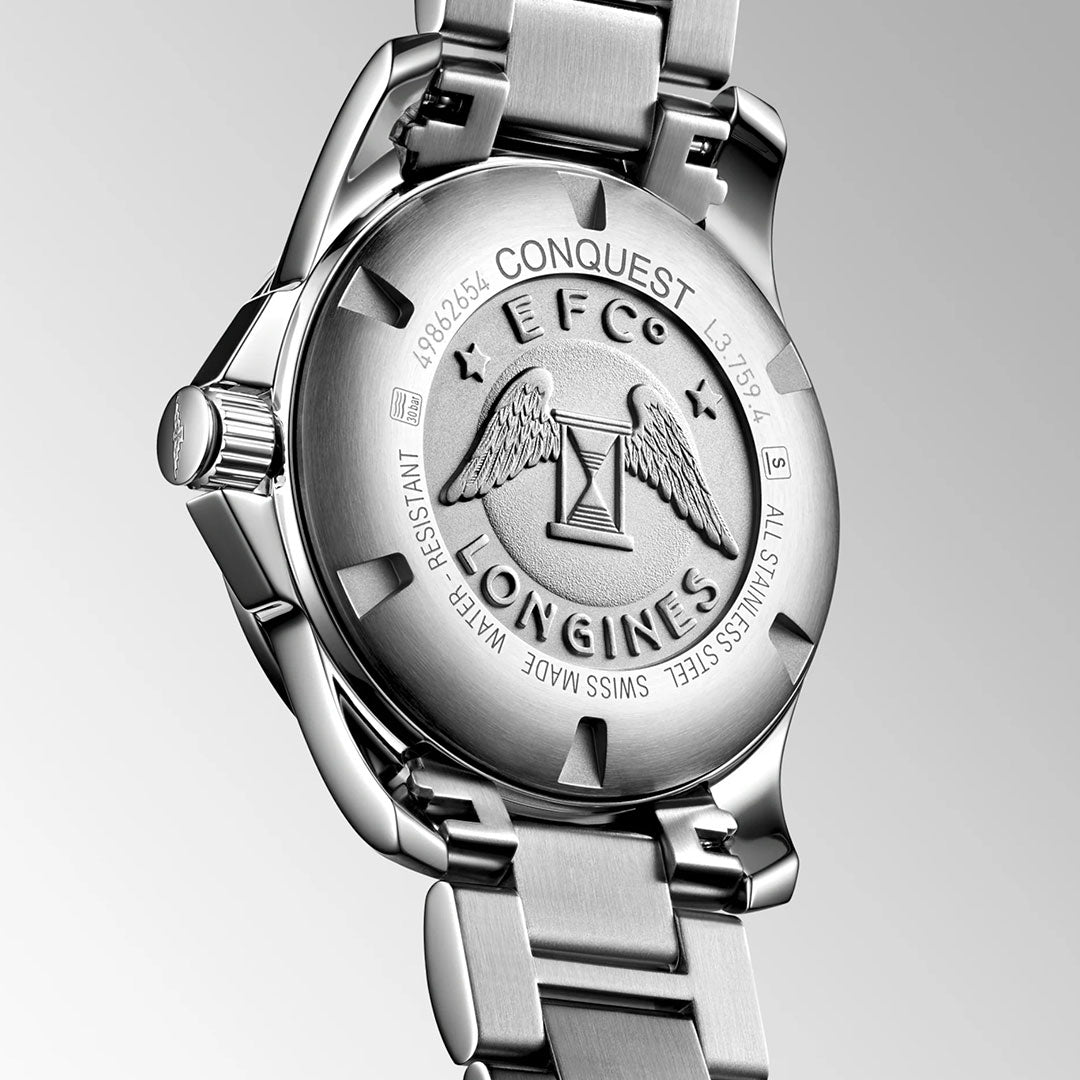 Close-up of the back of the Longines Conquest Quartz 41mm Watch, showcasing the engraved winged hourglass logo and text with model details, water resistance, and materials by Longines.