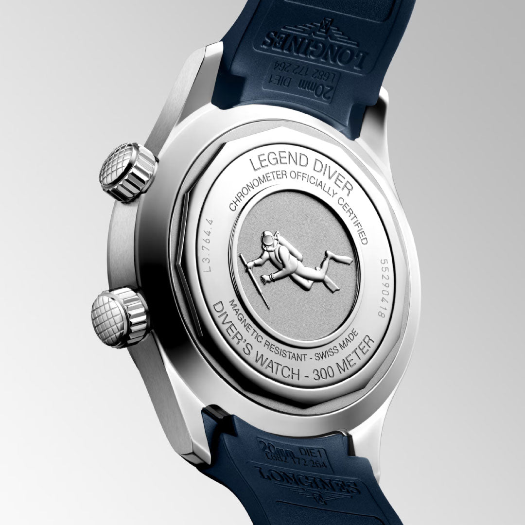 The back of a Longines Legend Diver Automatic 39mm Watch is shown, featuring a blue strap, stainless steel case with an engraved diver, 300m water resistance marking, and chronometer certification.