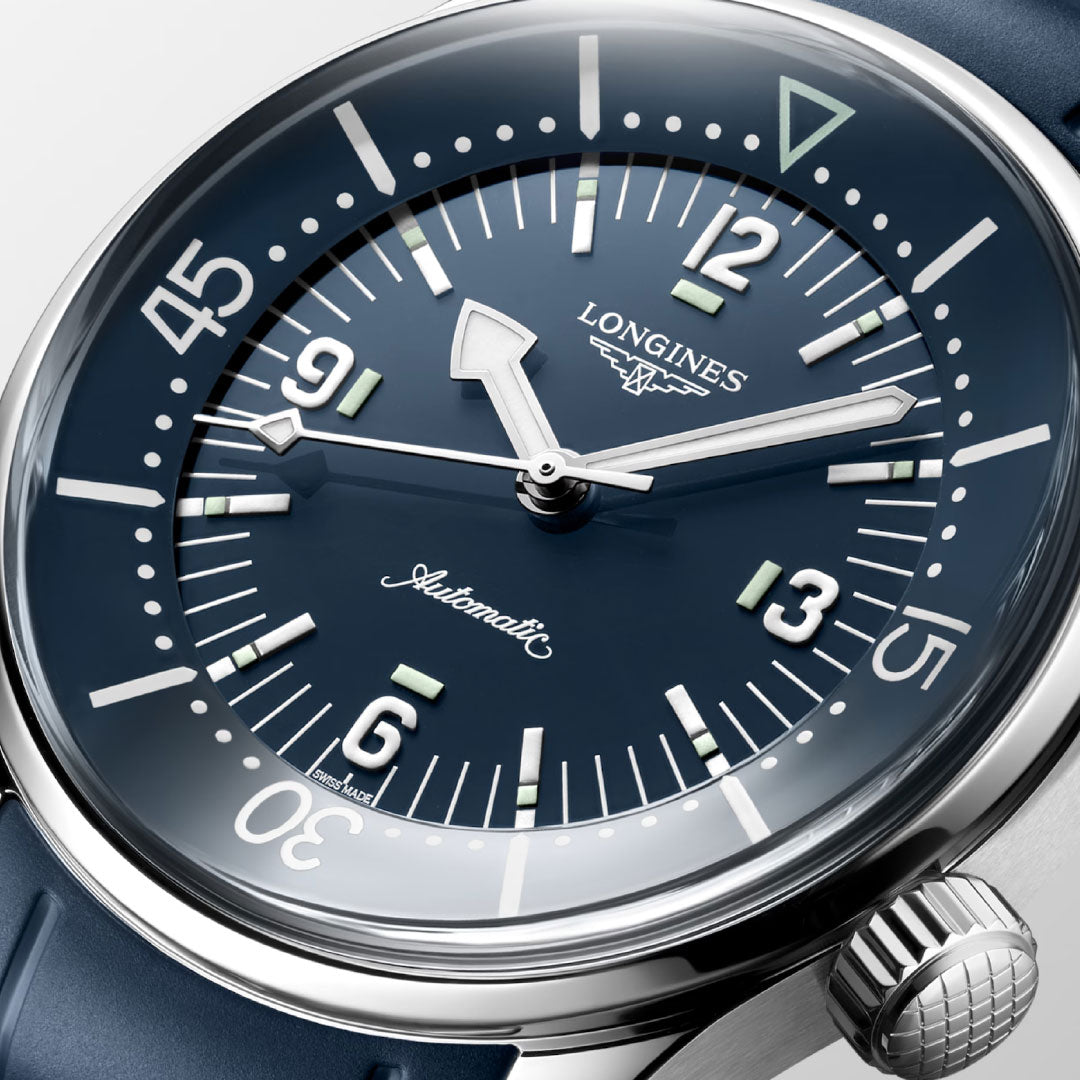 Close-up of the Longines Legend Diver Automatic 39mm Watch featuring a blue dial with silver indices, white numerals, internal rotating bezel, "Longines" and "Automatic" on the face, stainless steel case, and blue strap. Time is about 10:08:36.