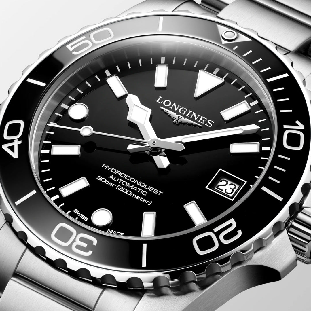 A close-up of the Longines Hydroconquest Automatic 39mm Watch showcases its black dial, bold white hour markers, date window at 3 o’clock, rotating bezel, Longines automatic movement, and 300m water resistance.