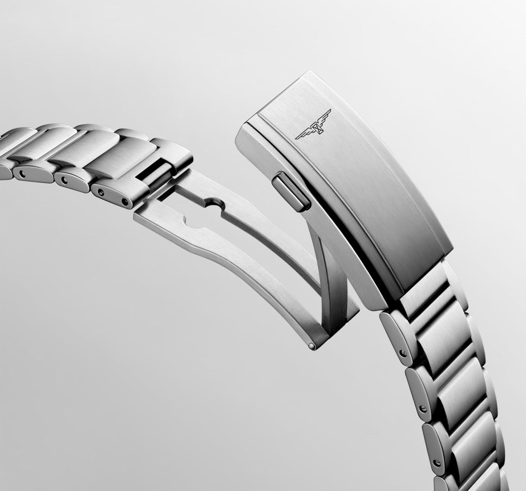 A close-up of the Longines Hydroconquest Automatic 42mm stainless steel bracelet with an engraved logo on its folding clasp, partially open, set against a plain light background. The Longines bracelet is water-resistant.