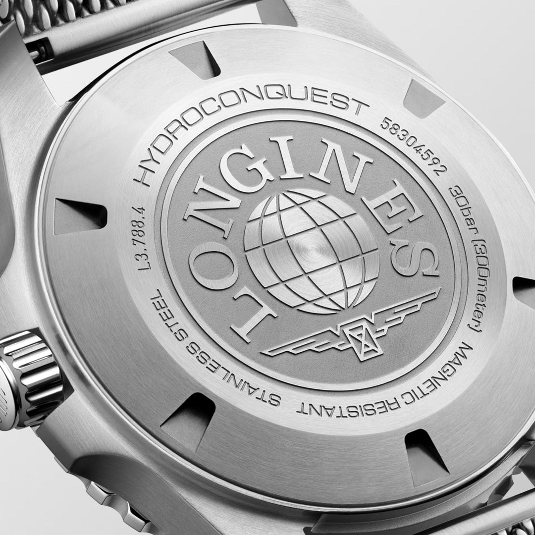 Close-up of the back of the Longines Hydroconquest Automatic 42mm Watch, displaying the engraved Longines logo, a globe motif, and technical details about its water-resistant design and automatic movement.