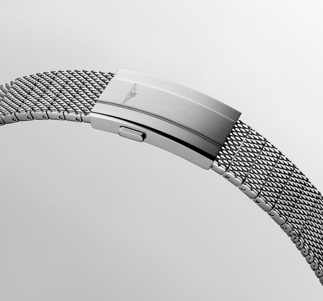 A close-up of the Longines Hydroconquest Automatic 42mm Watch shows its silver metal mesh strap with a polished clasp engraved with the HYDROCONQUEST logo, set against a plain light grey background.