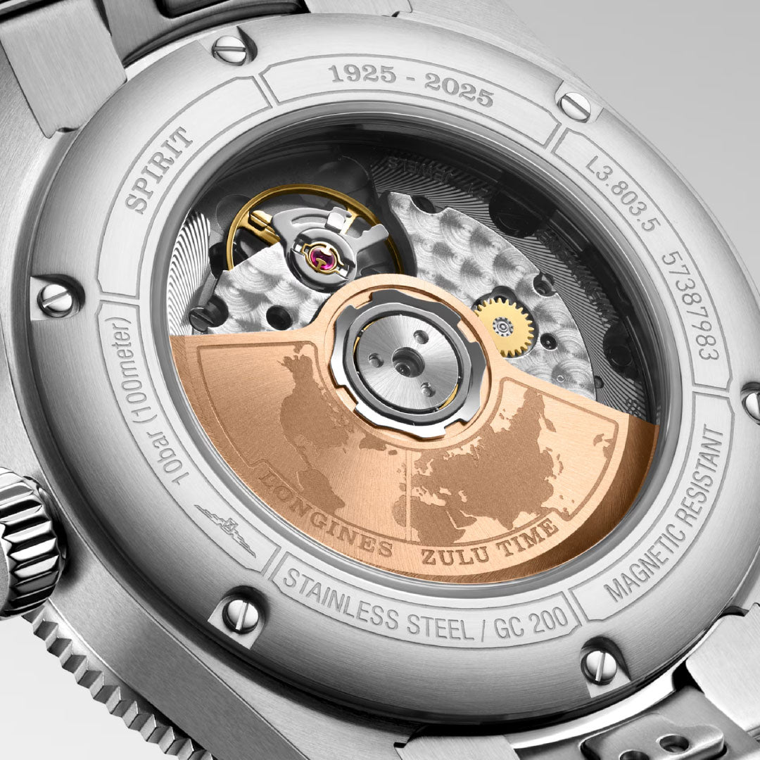 Close-up of the Longines Spirit Zulu Time 1925 Automatic 39mm shows its exposed mechanical movement and a rose gold rotor engraved with a world map and “Zulu Time,” surrounded by specifications and the years 1925–2025.