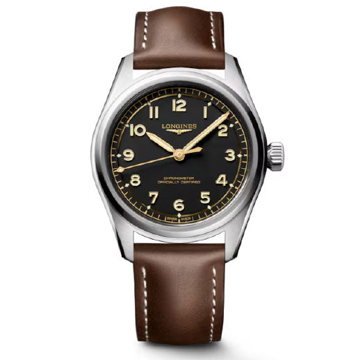 The Longines Spirit Pilot Automatic 39mm features a brown leather strap, stainless steel case, black dial with gold hour markers, a sweep second hand, and the Longines logo at 12 o’clock, inspired by classic aviator watches.