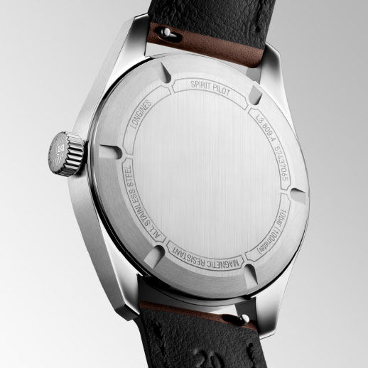 A close-up of the stainless steel back of the Longines Spirit Pilot Automatic 39mm Watch features engraved text like "LONGINES Spirit Pilot," "ALL STAINLESS STEEL," and "MAGNETIC RESISTANT," reflecting its chronometer certification.
