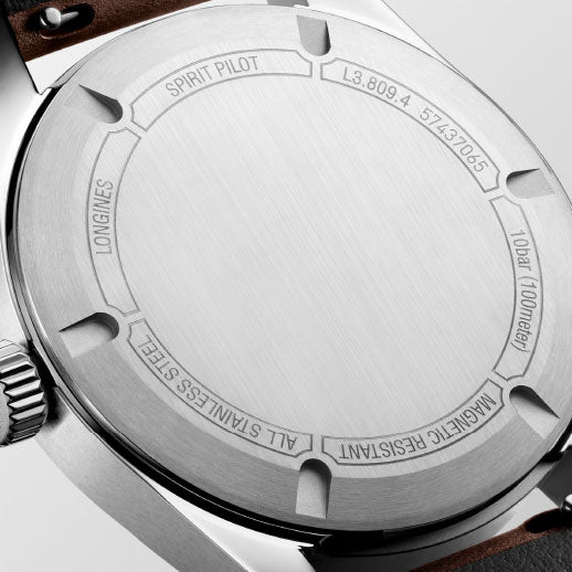 Close-up of the Longines Spirit Pilot Automatic 39mm Watch case back, displaying engravings: "SPIRIT PILOT,” “L3.809.4,” “10 bar (100 meters),” “MAGNETIC RESISTANT,” and chronometer certification from Longines.