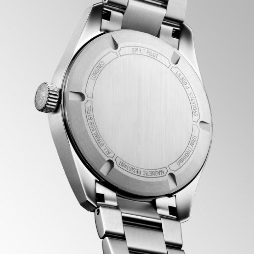 A close-up of the Longines Spirit Pilot Automatic 39mm Watch back shows engravings: "SPIRIT PILOT," "LONGINES," "STAINLESS STEEL," and "MAGNETIC RESISTANT," set against a gradient gray background.