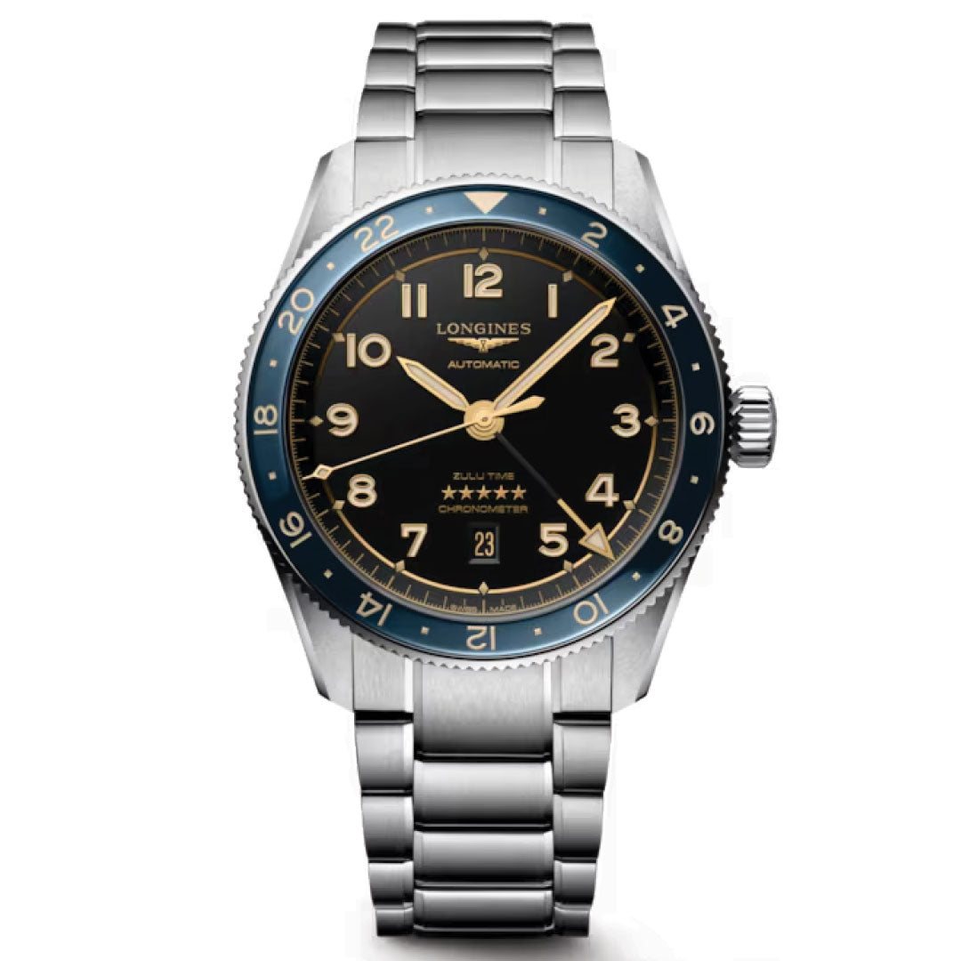 The Longines Spirit Zulu Time Automatic 42mm Watch features a stainless steel case, black dial with gold numerals, blue 24-hour bezel, silver bracelet, date at 6 o’clock, and five stars above "Chronometer." Chronometer-certified.