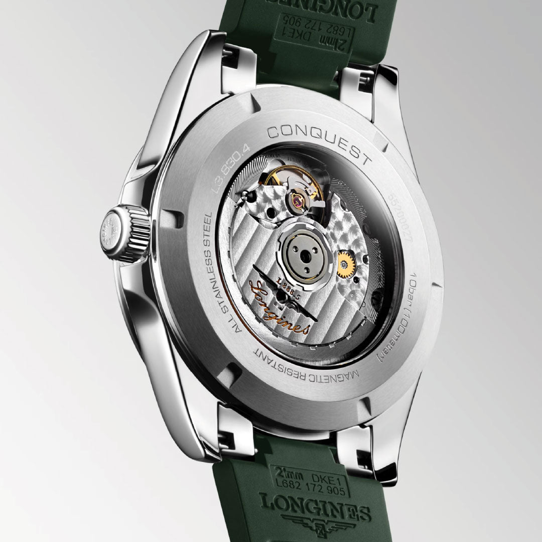 Close-up of the Longines Conquest Automatic 41mm Watch, highlighting its sporty elegance with a transparent caseback, visible movement, engraved details, and a green strap.