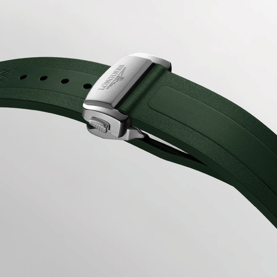 A close-up of the green rubber strap with silver clasp, engraved "Longines," highlights the sporty elegance of the Longines Conquest Automatic 41mm Watch against a light grey background.