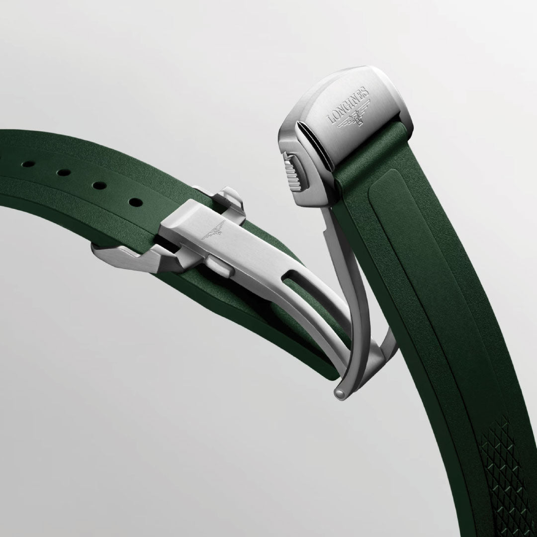Close-up of the Longines Conquest Automatic 41mm Watch's green rubber strap with a silver clasp engraved with the Longines logo, highlighting its sporty elegance against a plain light gray background.