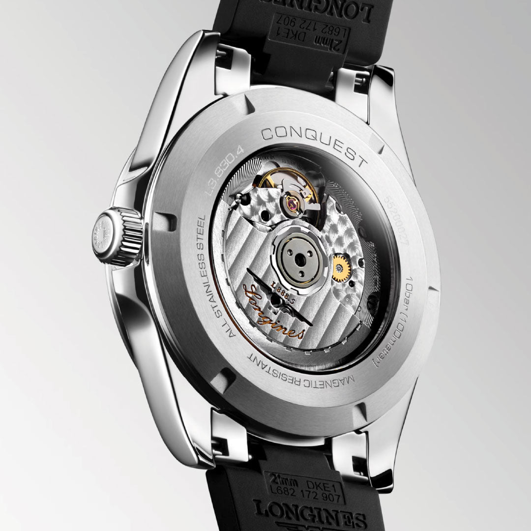 A close-up of the Longines Conquest Automatic 41mm Watch highlights its transparent case back with visible mechanical movement and engraved stainless steel details—an ideal everyday timepiece from Longines.