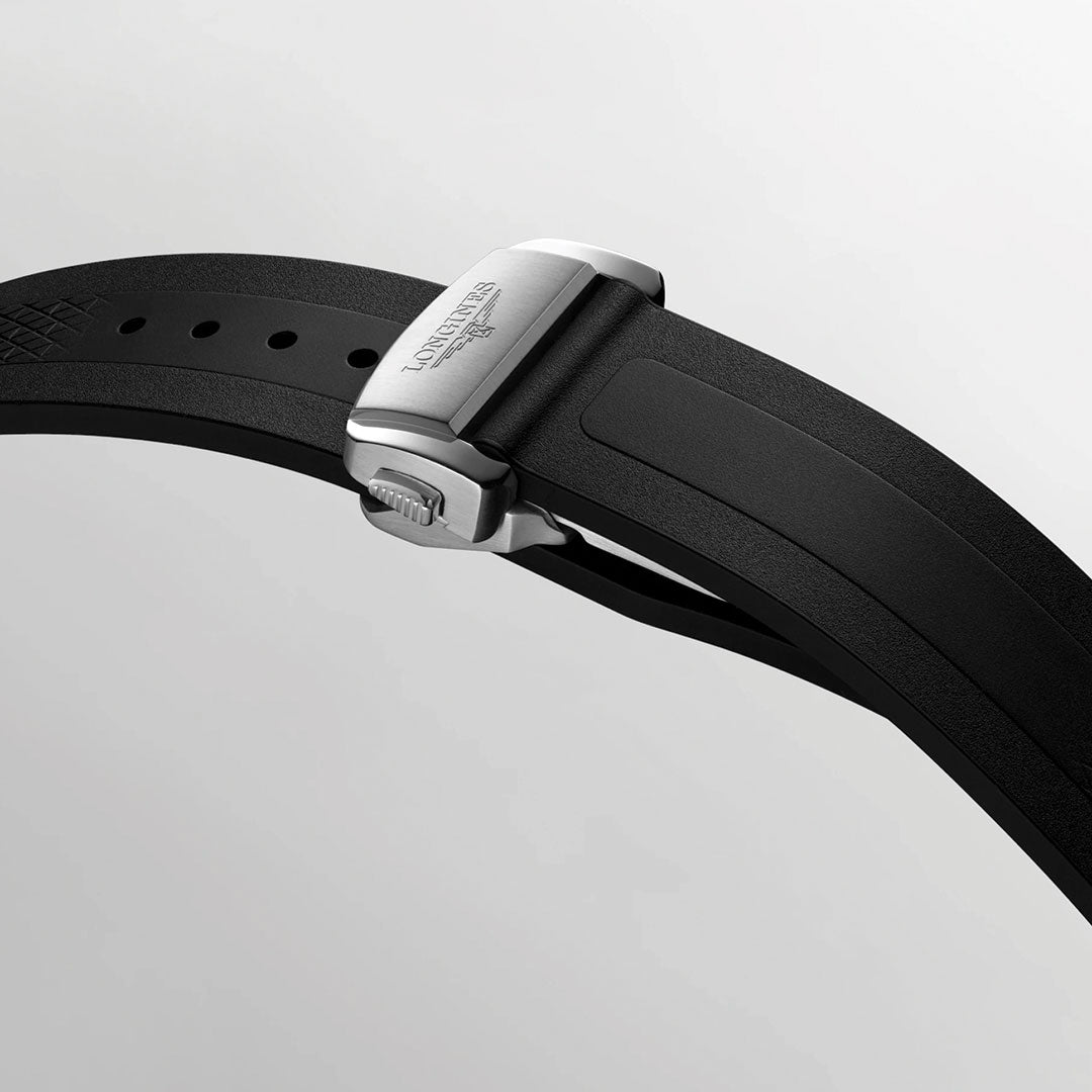 Close-up of the Longines Conquest Automatic 41mm Watch’s black rubber strap with a silver clasp engraved with the "Longines" logo—an elegant Swiss detail set against a plain light gray background.