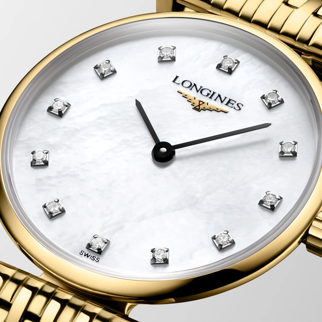 Close-up of the Longines La Grande Classique Quartz 24mm Watch featuring a gold link bracelet, white mother-of-pearl dial, diamond hour markers, and gold hands. This Longines timepiece showcases classic elegance with its minimalist design.