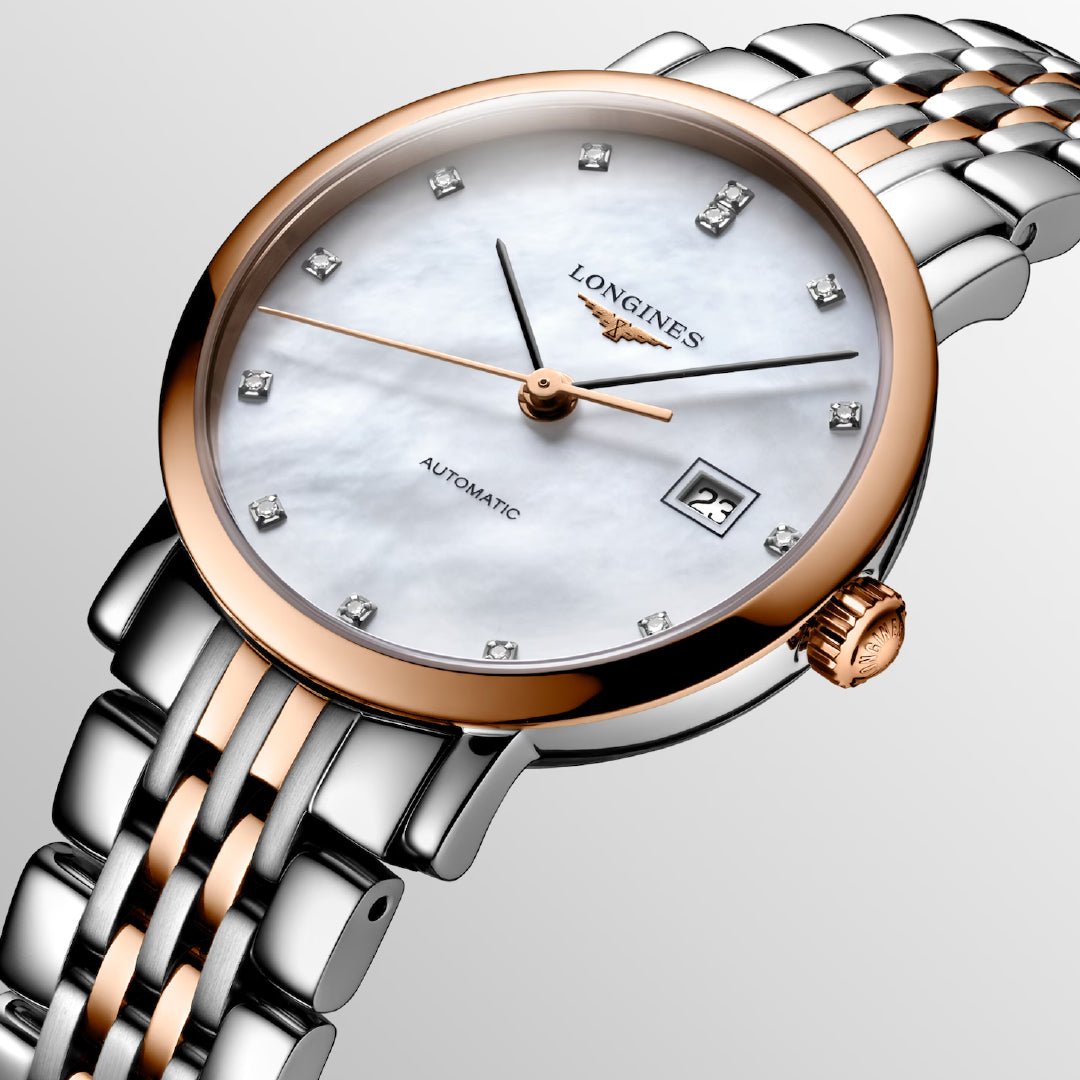 The Longines Elegant Collection Automatic 29mm Watch features a mother-of-pearl dial with diamond indices and a date window at 3 o'clock. It includes a two-tone silver and rose gold bracelet with a rose gold bezel, showcasing timeless elegance in exquisite watchmaking tradition.