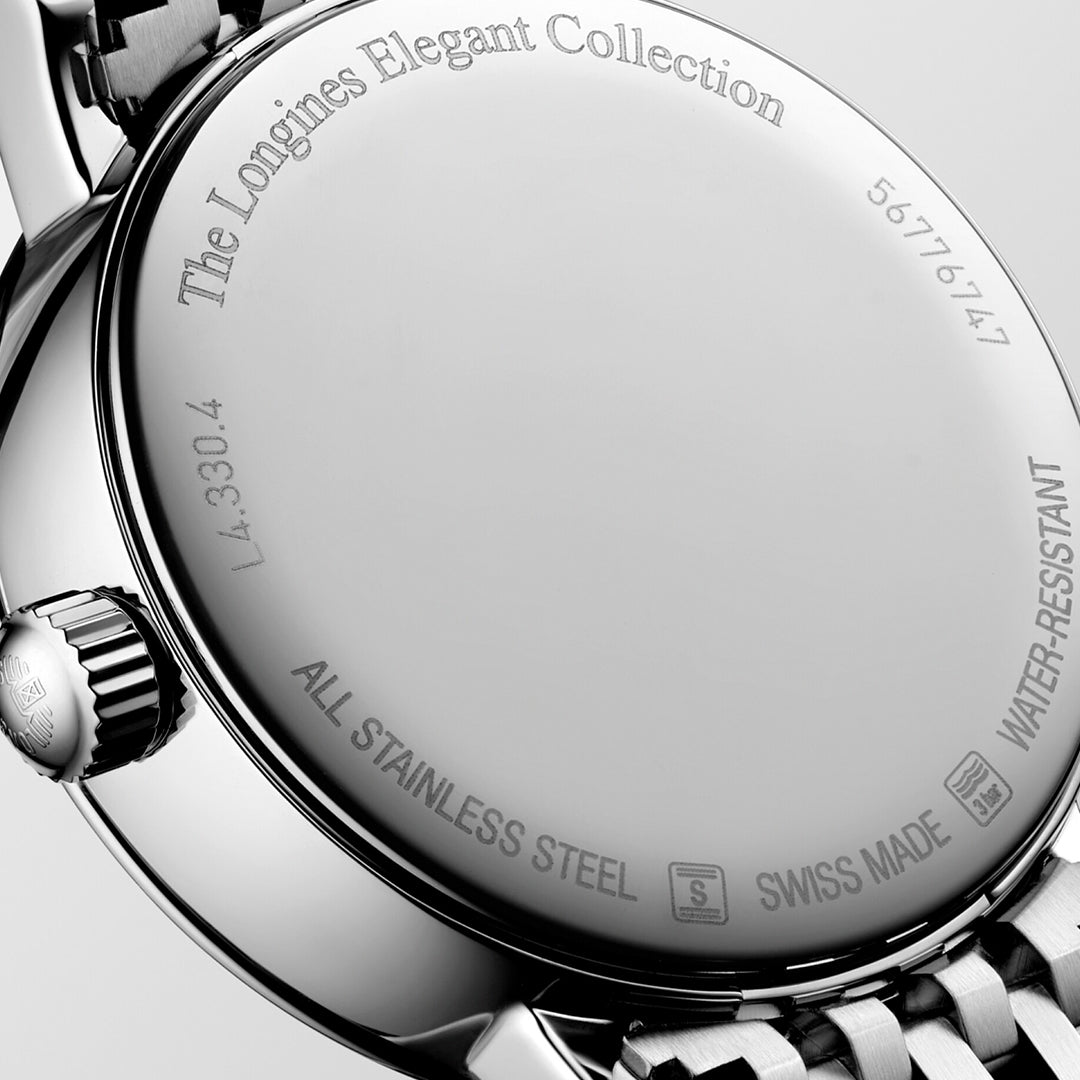 A close-up of the Longines Elegant Collection Moonphase Quartz 30mm Watch showcases the minimalist elegance of its design. The polished stainless steel back is adorned with engraved text, such as "ALL STAINLESS STEEL," "SWISS MADE," and "WATER-RESISTANT," highlighting Longines' enduring watchmaking heritage.