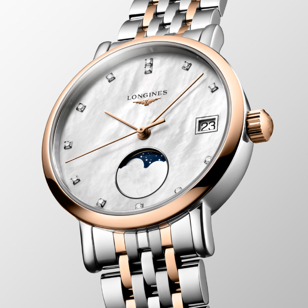 Explore the Longines Elegant Collection Moonphase Quartz 37mm Watch, a luxurious wristwatch by Longines. It features a sophisticated silver and rose gold metal band, highlighted by a white dial with diamond hour markers, a date display at 3 o'clock, and a moon phase subdial, epitomizing minimalist elegance and showcasing Longines' esteemed watchmaking tradition.