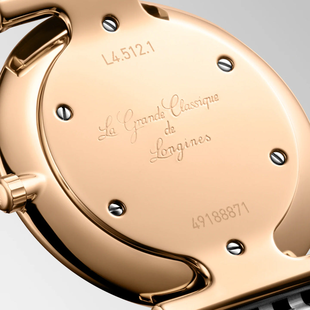 Close-up of the back of a Longines La Grande Classique Quartz 29mm watch, showcasing its classic elegance with engraved text, model number L4.512.1, serial number 49188871, and visible screws.