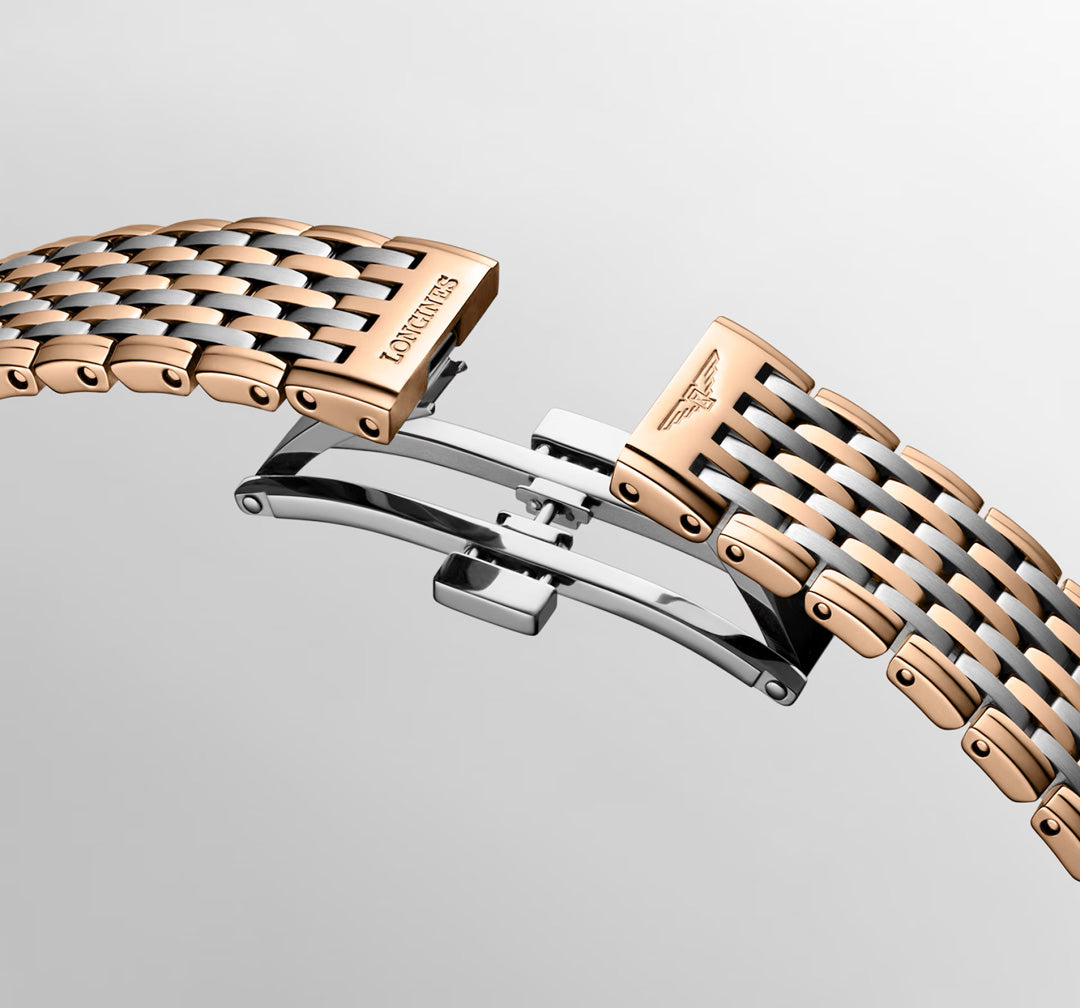 Close-up of the Longines La Grande Classique Quartz 29mm Watch bracelet, featuring elegant alternating polished steel and rose gold links, with the "LONGINES" name and winged hourglass logo on the folding clasp.