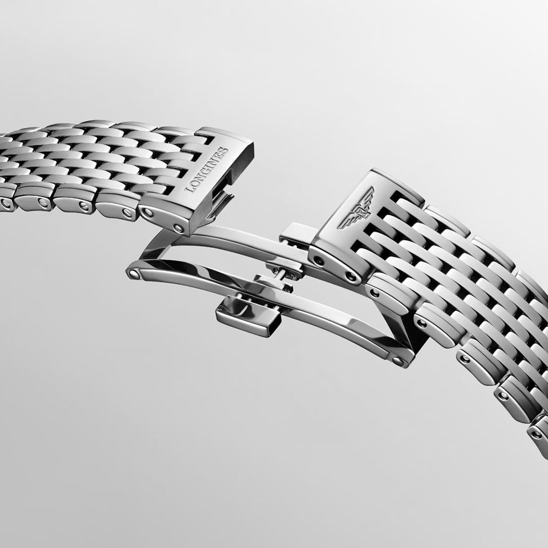 A close-up of the Longines La Grande Classique Quartz 29mm watch’s stainless steel bracelet with butterfly clasp, showcasing the engraved Longines logo and classic elegance against a plain light background.