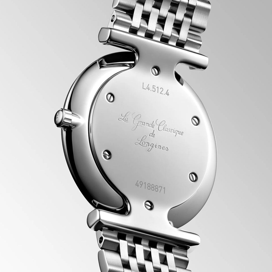 Close-up of the back of a Longines La Grande Classique Quartz 29mm Watch, engraved with its name, serial number, and reference number. The elegant silver strap stands out against a plain background.