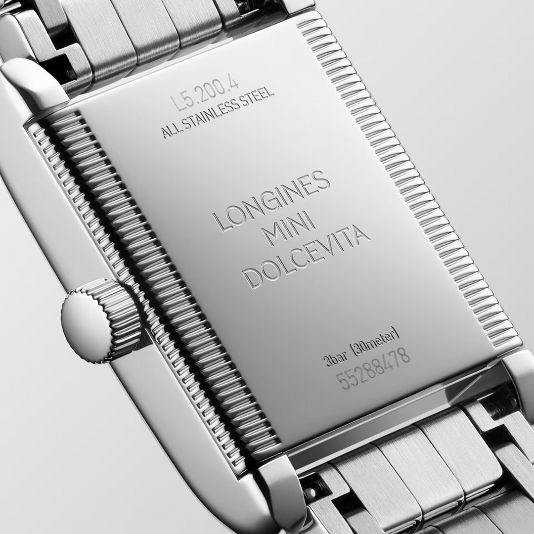 The stainless steel case back of a Longines Mini Dolcevita Quartz 21.5 x 29mm Watch with a metallic link bracelet, engraved with model number L5.200.4, product name, water resistance, and serial number.