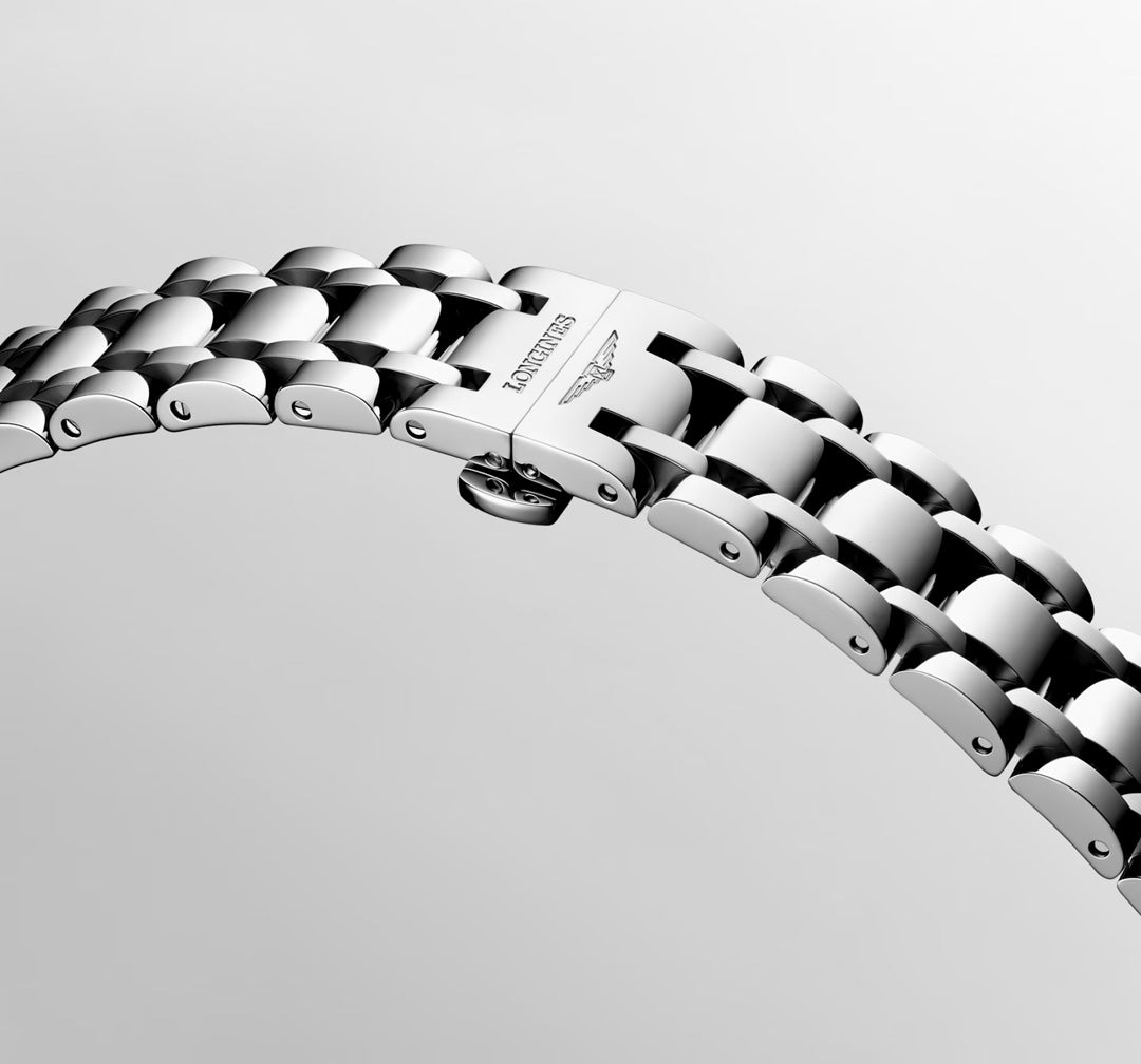 A close-up of a polished silver metal bracelet with a clasp engraved "Longines," displaying the Longines Dolcevita Quartz 20.8 x 32mm Watch against a light gray background, radiating the timeless elegance of luxury timepieces.