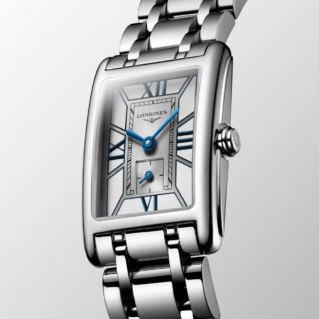 A close-up of the Longines Dolcevita Quartz 20.8 x 32mm watch showcases its rectangular silver face, blue hands, Roman numerals, and polished metal bracelet against a light gray background—timeless elegance by Longines.