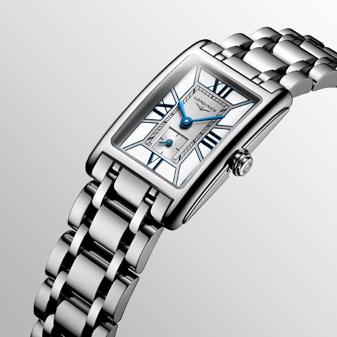 The Longines Dolcevita Quartz 20.8 x 32mm Watch showcases a rectangular stainless steel case, silver bracelet, white dial with blue hands, Roman numerals, and the Longines logo—an icon of timeless elegance.