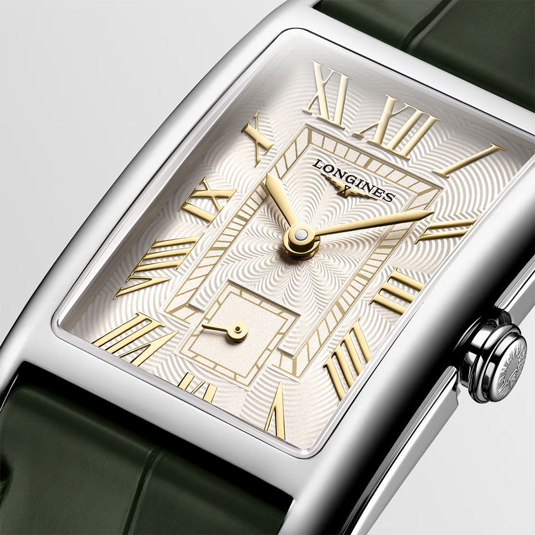 Close-up of the Longines Dolcevita Quartz 23.30 x 37mm watch featuring a rectangular stainless steel case, polished finish, silver guilloché dial with gold Roman numerals and hands, small seconds subdial, and a green alligator strap.