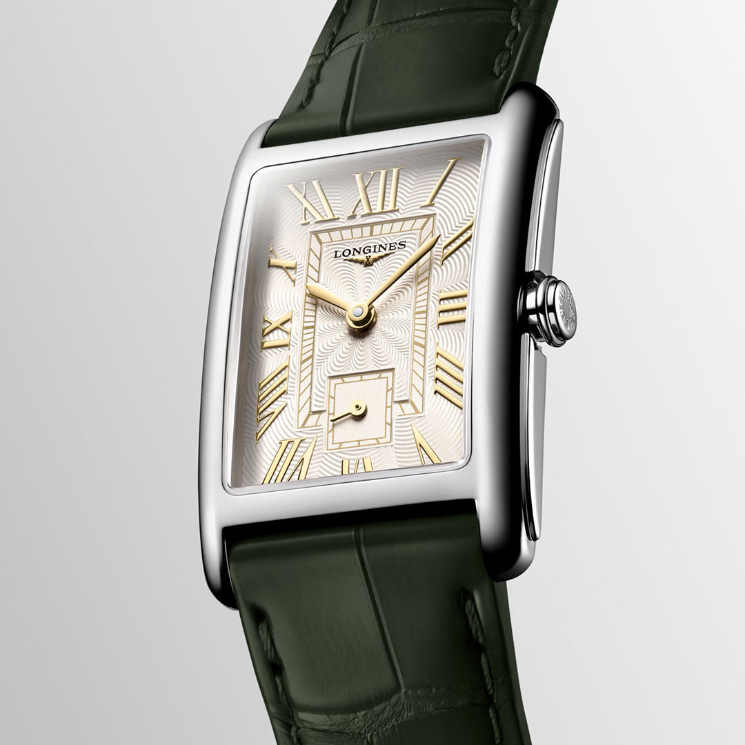 The Longines Dolcevita Quartz 23.30 x 37mm watch features a rectangular silver stainless steel case, gold Roman numerals and hands on a textured white dial, a green alligator strap, and a small seconds subdial above 6 o’clock.