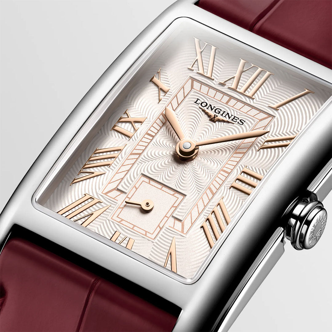 Showcasing timeless elegance, the Longines Dolcevita Quartz 23.3 x 37mm Watch is captured in a close-up: a rectangular case frames its silver dial with gold Roman numerals, complemented by a striking red leather strap. The luxury timepiece displays the time as 10:10 and features a small seconds subdial above the 6 o'clock mark.