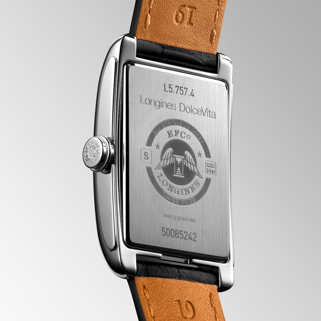 A close-up of the Longines Dolcevita Automatic 27.7 x 43.8mm Watch reveals its engraved stainless steel case back and brown leather strap—classic hallmarks of Longines' elegance and craftsmanship.