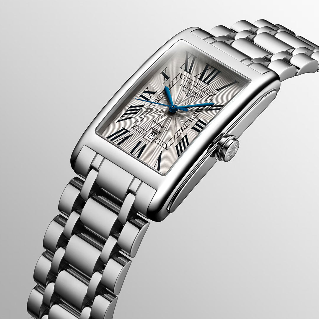 The Longines Dolcevita Automatic 28.2 x 47mm Watch exemplifies timeless elegance with its silver rectangular case, metal link bracelet, Roman numeral hour markers, blue hands, and a date display set against a light-colored dial. Inspired by the iconic Longines Dolcevita collection, this refined timepiece combines meticulous detailing with sophisticated style, making it a versatile choice for any occasion.