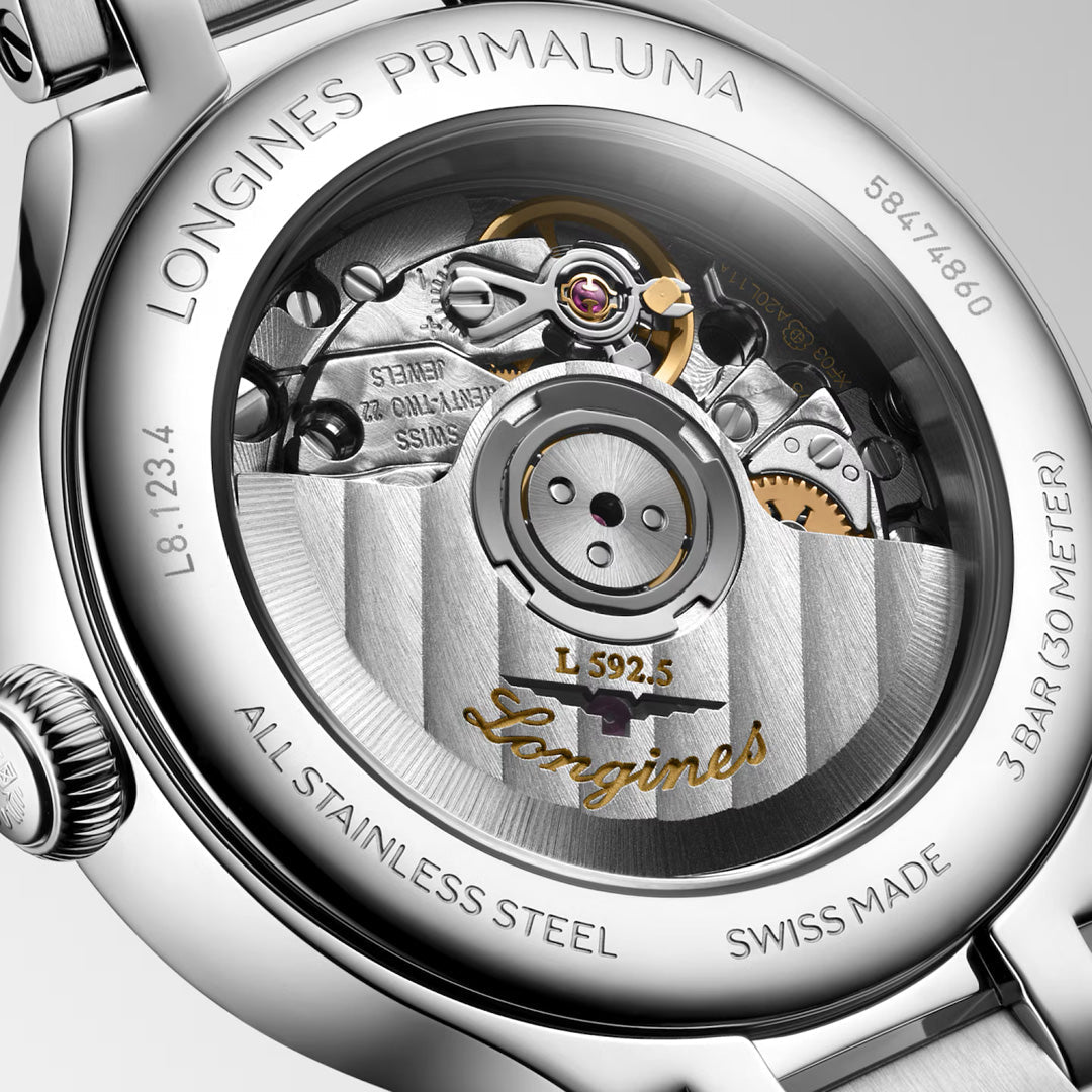 Close-up of the Longines Primaluna Automatic 30mm Watch, showcasing its detailed mechanical movement, engraved accents, visible gears, and Longines branding through a transparent case back.
