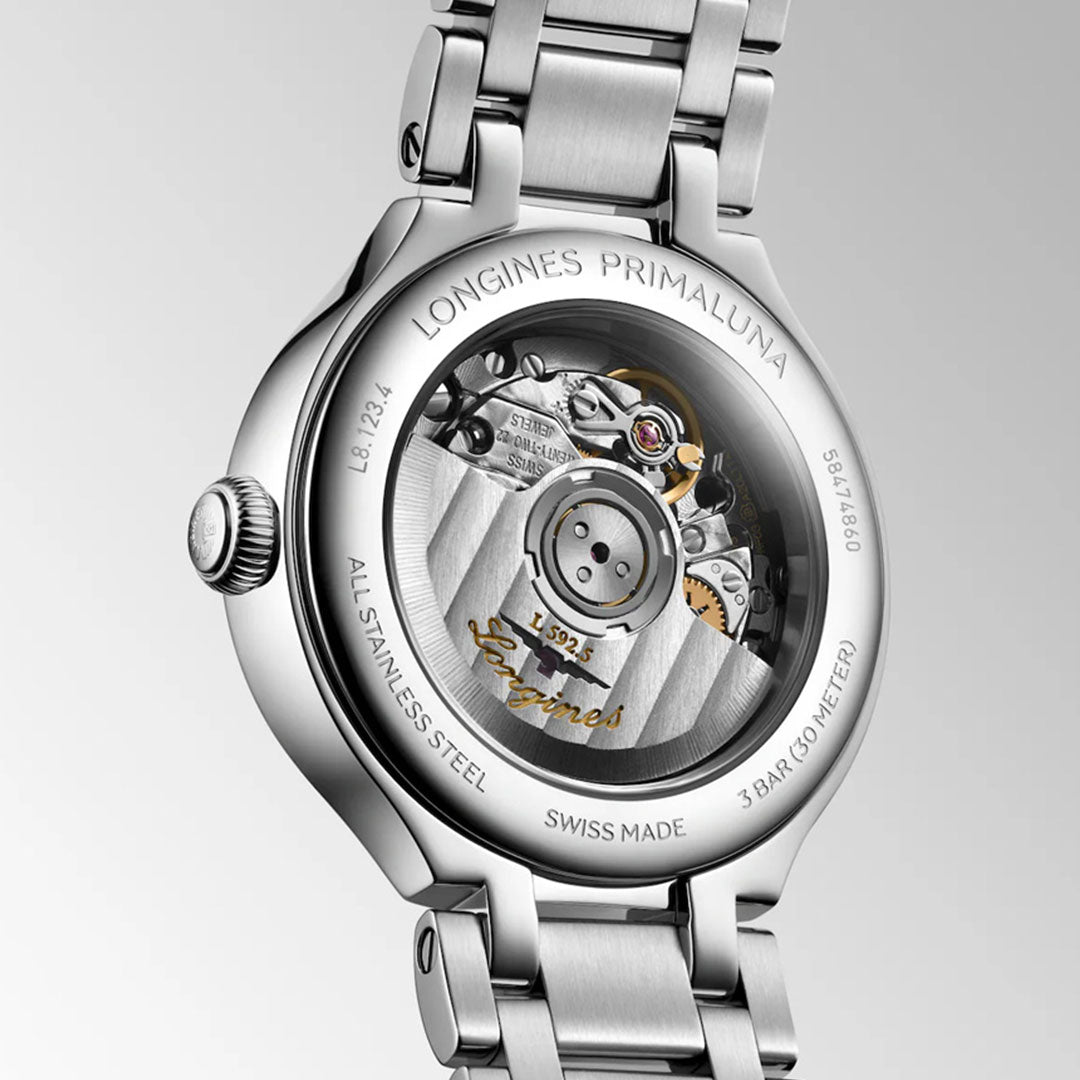 Close-up of the Longines Primaluna Automatic 30mm watch's back, revealing the transparent case that displays its fine mechanical movement and engraved Longines brand details on stainless steel.