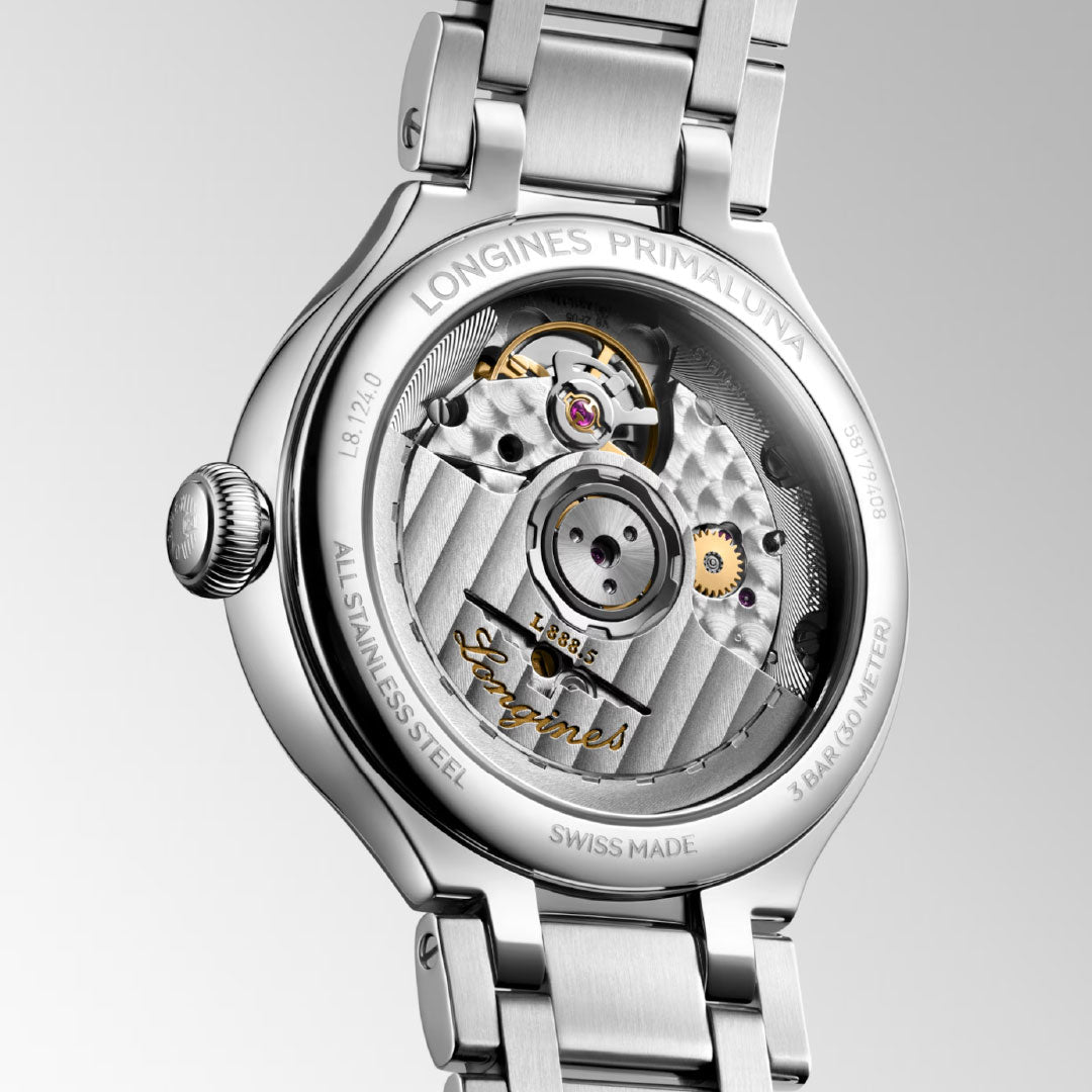 Close-up of the Longines Primaluna Automatic 34mm Watch, highlighting its stainless steel case, transparent back that reveals the mechanical movement, and engraved Longines branding on the edge.