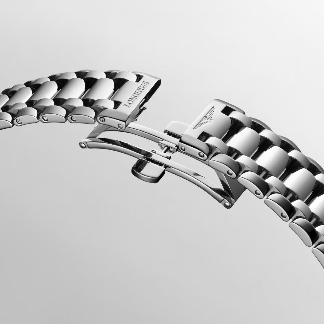 A close-up of the polished stainless steel bracelet and engraved clasp of the Longines Primaluna Automatic 34mm Watch, highlighting its elegant design against a simple background—an exquisite detail from Longines.