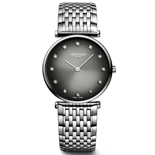 The Longines La Grande Classique Quartz 29mm Watch embodies classic elegance with its metallic bracelet and silver design, complemented by a dark gradient dial. It features diamond hour markers, elegant watch hands, and a scratch-resistant sapphire crystal, while the Longines brand name is prominently displayed below the 12 o'clock position.