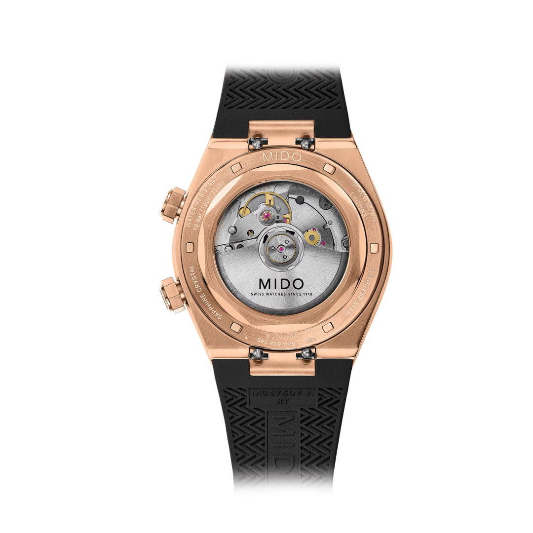 Back view of the MIDO Multifort 8 Two Crowns Automatic 40mm Watch by MIDO, featuring an exposed Calibre 72 with Nivachron mechanical movement, rose gold-tone case, and a black rubber strap emblazoned with the MIDO logo.