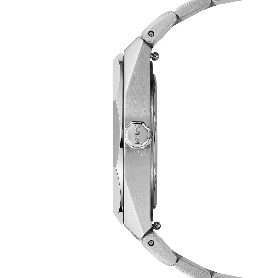 Side view of the MIDO Multifort 8 One Crown Automatic 40mm Watch, showcasing its sleek silver brushed metal finish, octagonal bezel, “OCTO” engraved crown, and metal bracelet—all highlighting precise Swiss automatic movement.