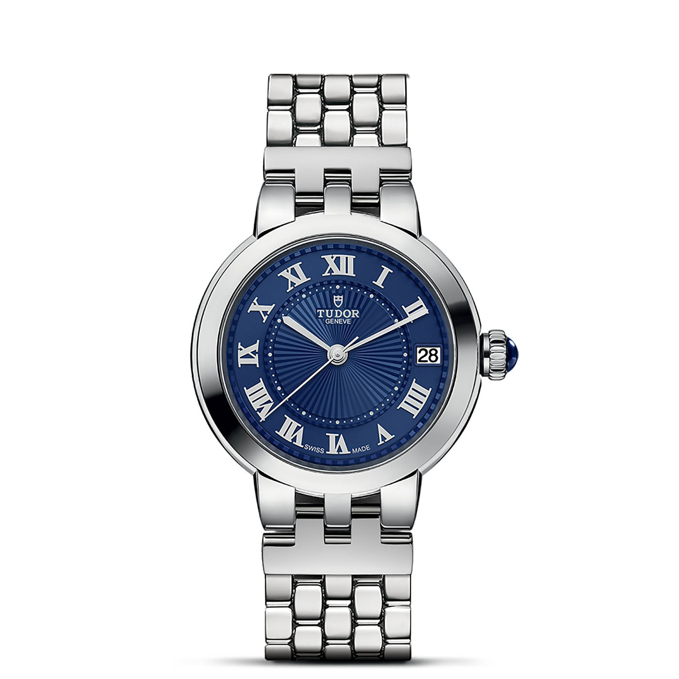 The TUDOR Clair de Rose wristwatch combines a polished silver bracelet with a deep blue dial, adorned with blue lacquered Roman numerals and a date display at the 3 o'clock position. The decorative crown and intricate detailing emphasize its elegant design.