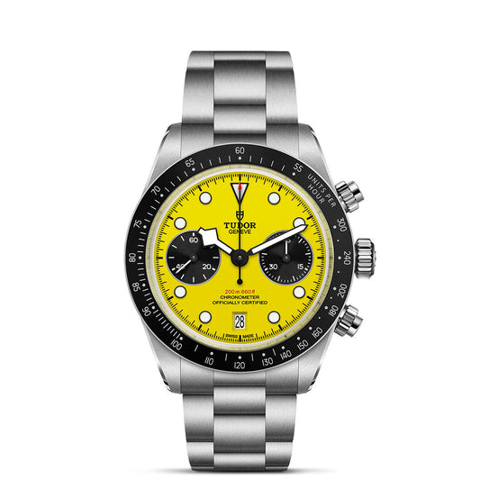The TUDOR Black Bay Chrono 39 is a stainless steel wristwatch with a bright yellow dial, black subdials and bezel, 39mm case, date window, chronograph pushers, TUDOR logo and Manufacture Chronograph Calibre.