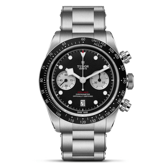 The TUDOR Black Bay Chrono features a stainless steel sports chronograph design with a black dial, white subdials, and a tachymeter scale on the bezel. It includes a T-Fit clasp on the bracelet and three side buttons for versatile functionality.