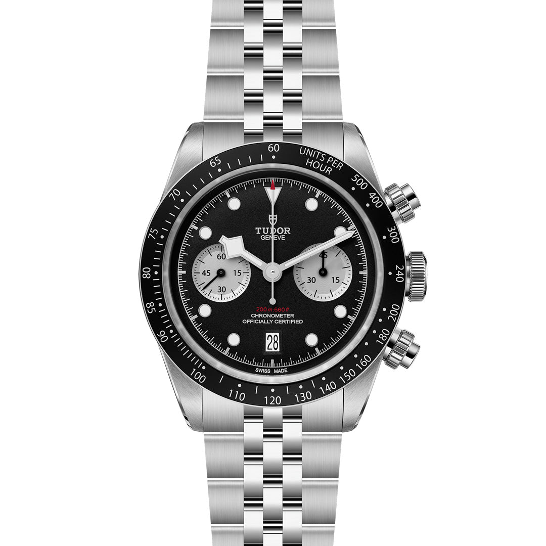 The TUDOR Black Bay Chrono features a silver five-link metal band with a T-Fit clasp, a black chronograph dial with three sub-dials, a date display, and side pushers. It also has an elegantly marked tachymeter scale around the rim.