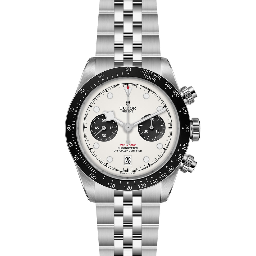 The TUDOR Black Bay Chrono watch boasts a silver design with a black bezel, white dial, black subdials, date at 6 o'clock, and a stainless-steel bracelet featuring an advanced T-Fit clasp, epitomizing its status as a top sports chronograph.